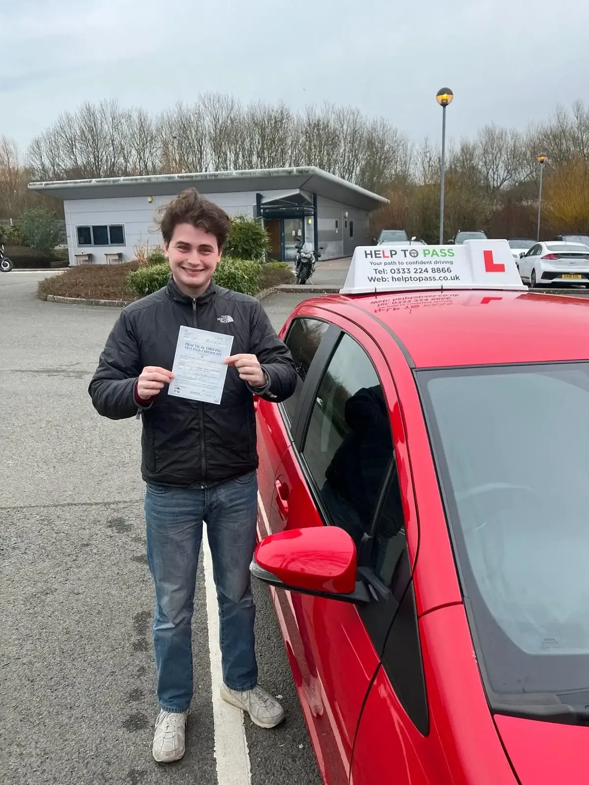 Alex Jee, holding his practical driving test pass certificate
